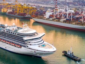 Luxury cruise ship proceed on sailing from port channel due on sunrise– maritime industry insights